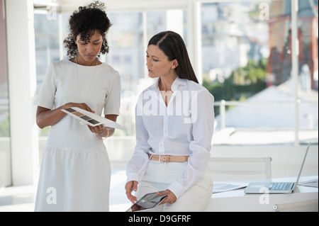 Interior designer showing color swatches to a woman Stock Photo