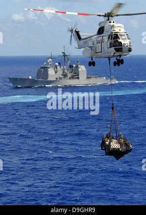 An AS-332 Super Puma helicopter delivering supplies. Stock Photo