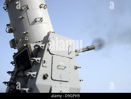 A close-in weapons system fires during an operational test aboard USS Vicksburg. Stock Photo