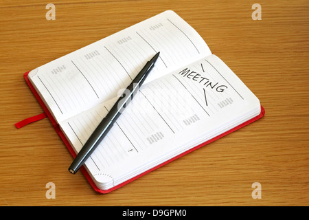 Day booked out for meeting in generic diary Stock Photo