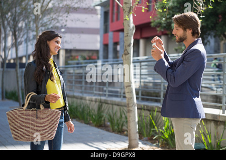 Man taking picture of his friend with a mobile phone Stock Photo