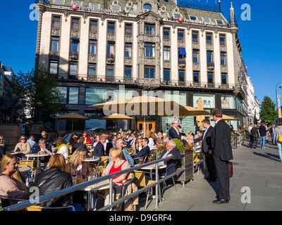 Bar cafe in Oslo, Norway, Scandinavia, Europe in the early evening with people sitting outside in the sun Stock Photo