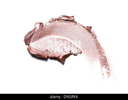 pink gold cream eyeshadow smear cut out onto a white background Stock Photo