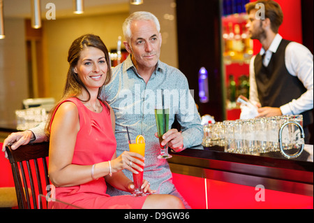 Couple enjoying drinks at the bar counter Stock Photo