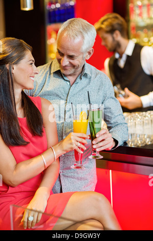 Couple enjoying drinks at the bar counter Stock Photo