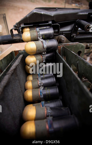 Linked 40mm rounds feed into a Mark 19 grenade launcher. Stock Photo