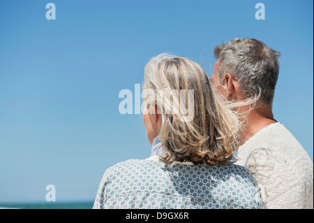 Couple standing on the beach Stock Photo