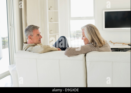 Couple sitting on a couch Stock Photo