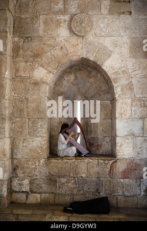 Woman playing the harp at Jaffa gate in the old city, Jerusalem, Israel. Stock Photo