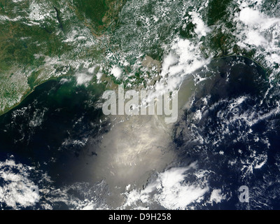 Satellite view of streaks and ribbons of oil brighten the reflection of the Sun off the Gulf of Mexico. Stock Photo