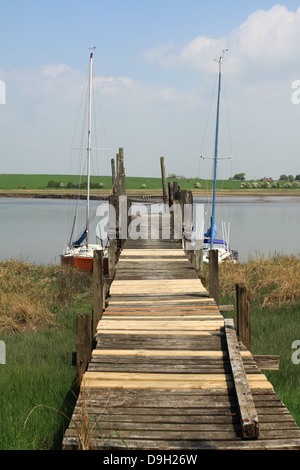 Two sailing yachts moored to old wooden jetty at historic Skippool Creek Thornton Lancashire UK. Stock Photo