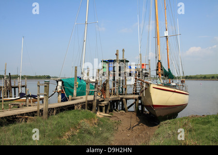 Sailing yachts moored to old wooden jetty at historic Skippool Creek on the river Wyre at Thornton Lancashire UK. Stock Photo