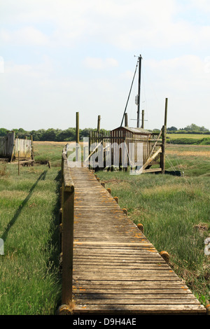 Old wooden jetty and huts at low tide at historic Skippool Creek Thornton Lancashire UK Stock Photo