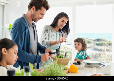 Family preparing food in the kitchen Stock Photo