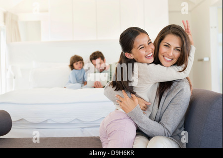 Portrait of a woman hugging her daughter Stock Photo