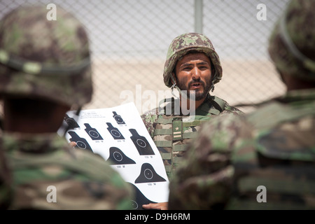 An Afghan National Army soldier with the Kandak Special Operations forces briefs fellow soldiers before a live-fire exercise May 20, 2013 in Camp Shorabak, Afghanistan. Stock Photo