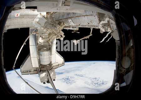 The docked space shuttle Discovery and Dextre. Stock Photo