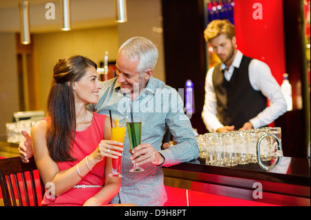 Couple enjoying drinks at the bar counter Stock Photo