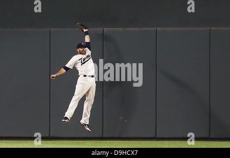 Minneapolis, Mn, USA 19th June, 2013. June 19, 2013: Minnesota Twins right fielder Ryan Doumit (9) makes a leaping catch against the wall during the Major League Baseball game between the Minnesota Twins and the Chicago White Sox at Target Field in Minneapolis, Minn. Credit: csm/Alamy Live News Stock Photo