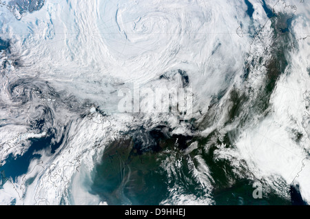Satellite view of large and powerful cyclone churning over the Arctic. Stock Photo