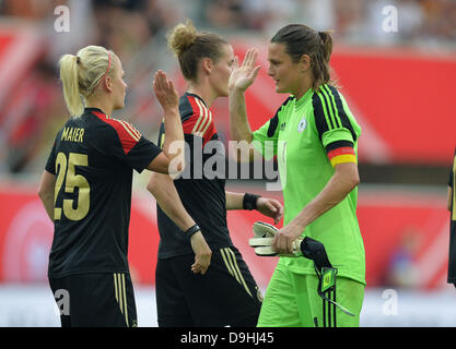 Germany's Leonie Maier (L) high fives Germany's goalkeeper Nadine Angerer after the international soccer match between Germany and Canada at Benteler Arena in Paderborn, Germany, 19 June 2013. Germany's Simone Laudehr stands between them. Photo: Carmen Jaspersen Stock Photo