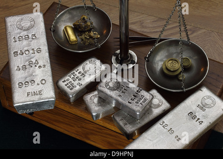 Silver Bullion Bars (Ingots) on Antique Balance Scale - Gold Bar and Natural Gold Nuggets being Weighed on Scale Stock Photo