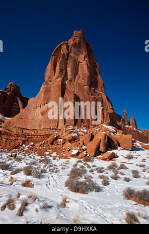 Large red sandstone rock formation with snow in winter, Arches National Park, Utah, United States of America Stock Photo