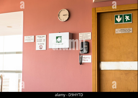Emergency exit door with first aid kit and emergency phone Stock Photo
