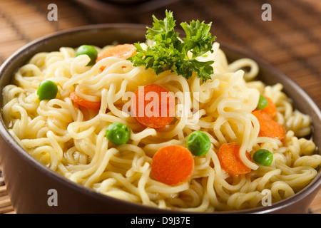 Homemade Quick Ramen Noodles with carrots and peas Stock Photo