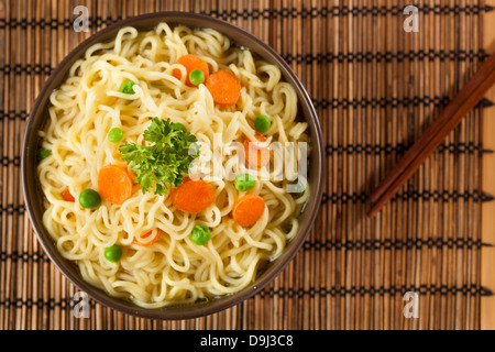Homemade Quick Ramen Noodles with carrots and peas Stock Photo