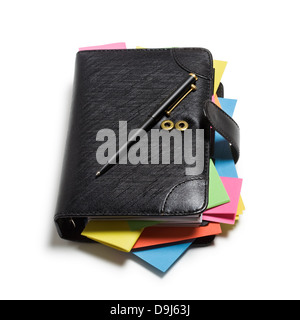 Black notebook with colorful note papers and pen on white background, clipping path included Stock Photo