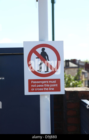 sign on the platform passengers must not pass this point or cross the line at Longton railway station platform England UK Stock Photo