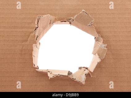 Ripped hole in cardboard on white background Stock Photo