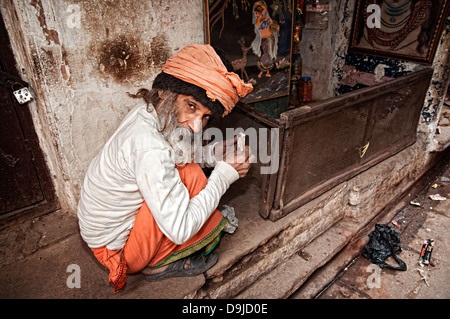 Man about to smoke a biri (indian cigarett) in the narrow street of Varanasi, Benares, Uttar Pradesh, India Stock Photo