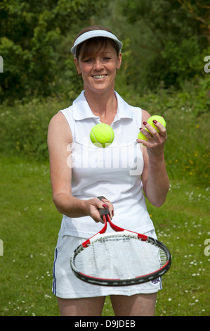 Female tennis player with racquet and balls. Stock Photo