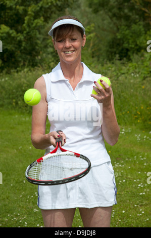 Female tennis player with racquet and balls. Stock Photo