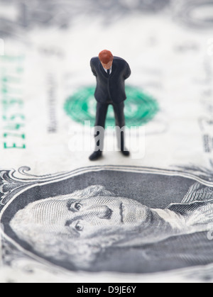 Figure of businessman on one dollar bill Stock Photo