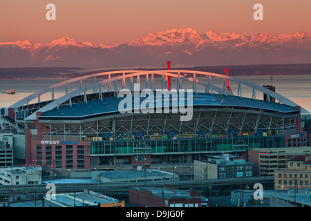 The Olympic Mountains tower above Qwest Field in the early morning hours, as seen from Dr. Jose Rizal Park, Seatte, Washington. Stock Photo