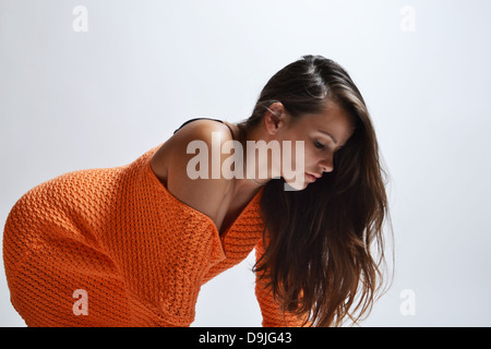 beautiful woman in orange sweater Stock Photo