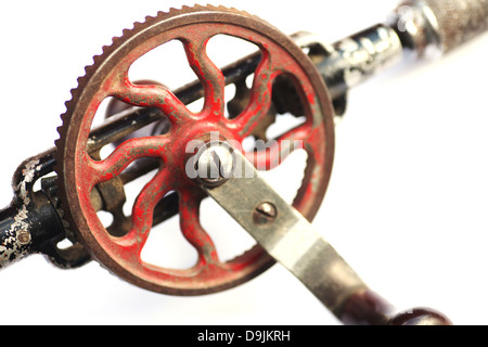 old hand drill with crank on white Stock Photo