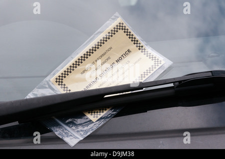 A parking ticket on a car windscreen. Stock Photo