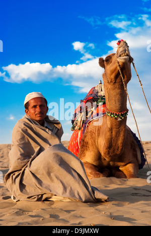 Cameleer waits for  customers at the Sam Sand Dune in Jaisalmer, India. Stock Photo
