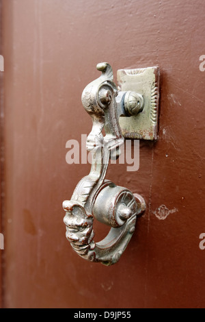 old traditional brass worn painted door knocker on a french door mont-louis pyrenees-orientales france Stock Photo