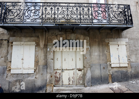 old worn painted flaking wooden doorway in historic house mont-louis pyrenees-orientales france Stock Photo