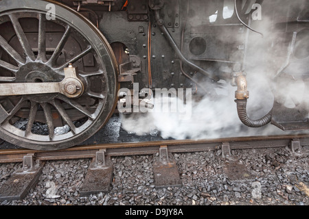 Close up of wheels and couplings on steam train at the Bluebell Railway, East Grinstead, West Sussex, UK Stock Photo