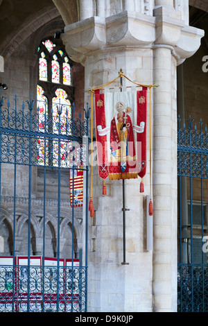 Banner bearing an image of a priest inside Peterborough Cathedral, England Stock Photo