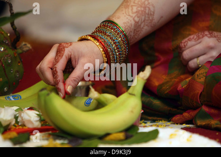 Hindu India Indian Vishnu blessing wedding ceremony leaves spices rice banana religious Stock Photo