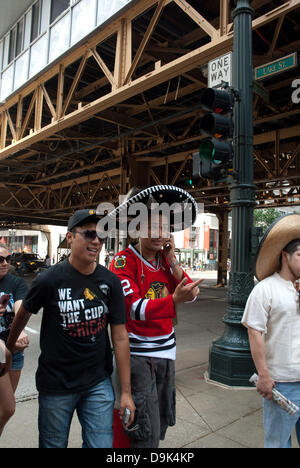 Jun 11, 2010 - Chicago, Illinois, U.S. - Blackhawk fans stroll on Wabash Avenue. Parade on Michigan Avenue to celebrate the Stanley Cup 2010 championship win of the Chicago Blackhawks hockey team. Chicago Blackhawk players and organization members ride on top of English double decker buses greeting the crowd that has gathered to honor them. (Credit Image: © Karen I. Hirsch/ZUMAPRESS.com) Stock Photo