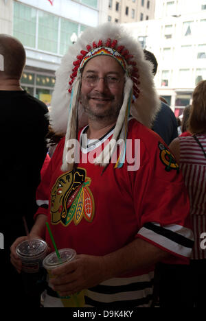 Jun 11, 2010 - Chicago, Illinois, U.S. - Fan dons Blackhawk regalia in celebration. Parade on Michigan Avenue to celebrate the Stanley Cup 2010 championship win of the Chicago Blackhawks hockey team. Chicago Blackhawk players and organization members ride on top of English double decker buses greeting the crowd that has gathered to honor them. (Credit Image: © Karen I. Hirsch/ZUMAPRESS.com) Stock Photo