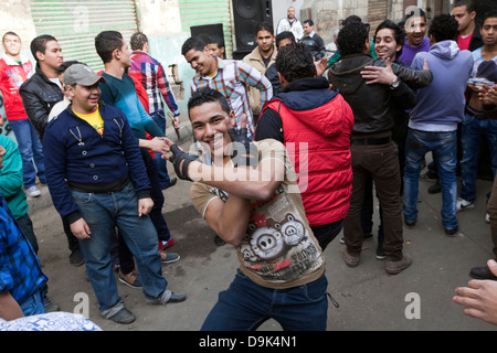 Boys and youth dance to a sound system in the streets to celebrate a wedding, Islamic Cairo, Cairo, Egypt Stock Photo